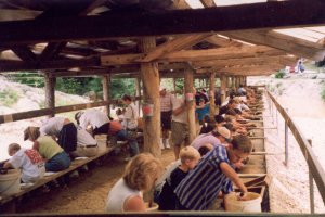 People gem mining at a flume