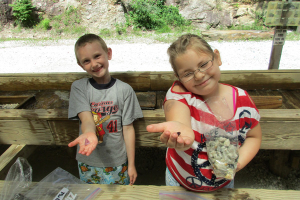 Two kids holding gemstones