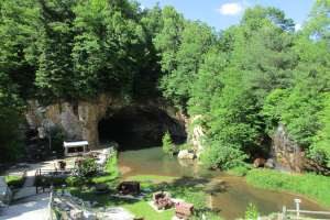 A historic mine with a waterfall and old mining equipment at Emerald Village in Little Switzerland, NC