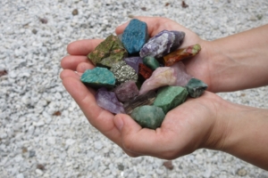 Hands holding gemstones